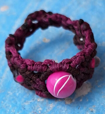 Handmade macramé ring with pink bead from the Road Talismans collection